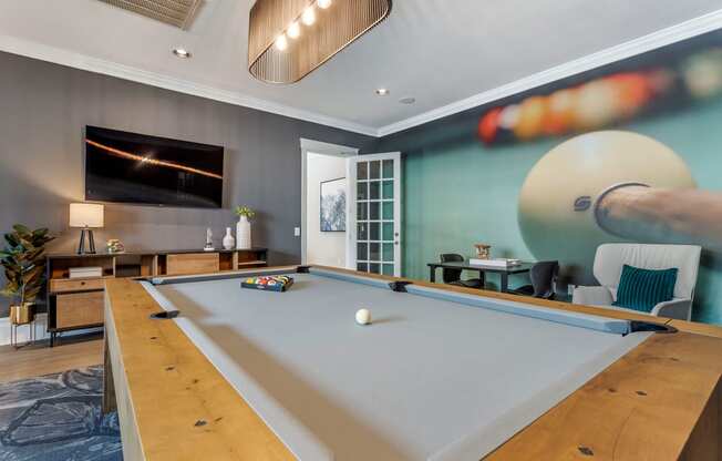 a game room with a pool table and a tv at Reserve by the Lake, Houston, TX, 77084