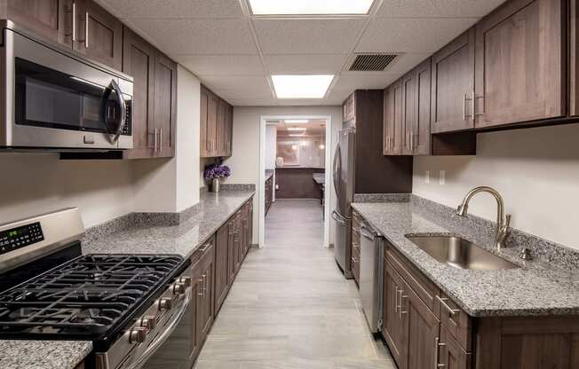 a kitchen with granite counter tops and wooden cabinets