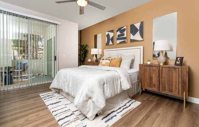 a bedroom with a bed and a ceiling fan