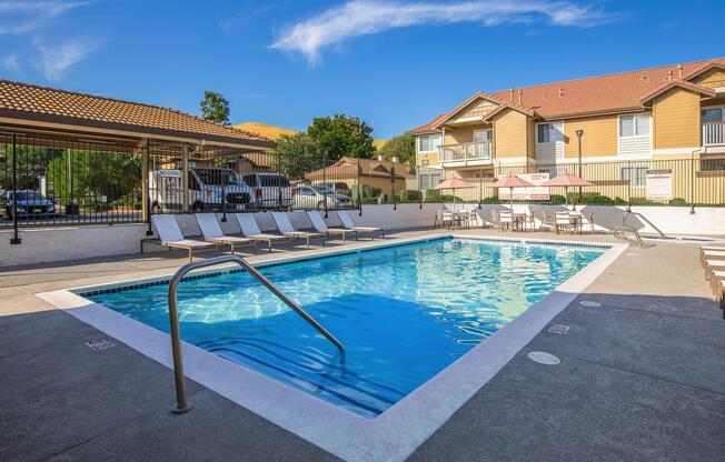 a house with a pool in front of a building