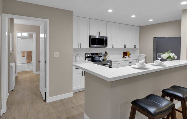 a kitchen with an island and two stools