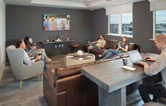 A group of people are sitting in a modern lounge area.