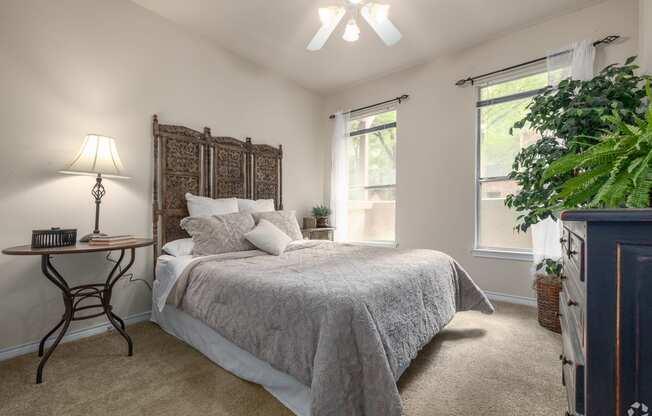 a bedroom with a bed and a dresser and a window