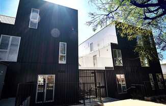 A black building with a tree in front of it.at The Dillon, Los Angeles