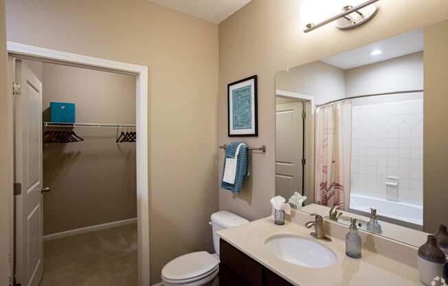 a bathroom with a sink and a toilet and a shower