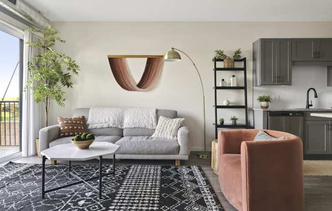 a living room with a white couch and a black and white rug