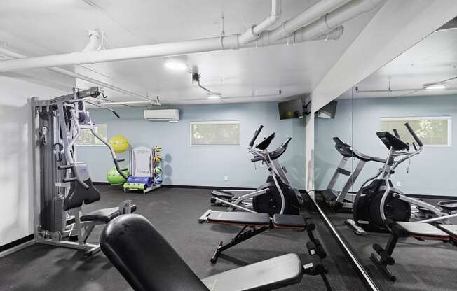 a gym with exercise equipment and a yellow exercise ball at King Arthurs Court, Seattle