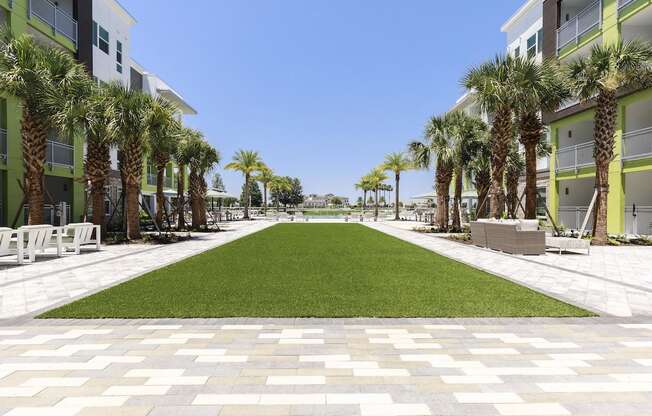Green lawn area leading to pool at Residences at The Green in Lakewood Ranch, FL