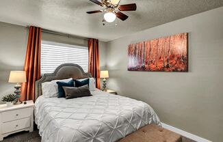 a bedroom with a bed and a ceiling fan