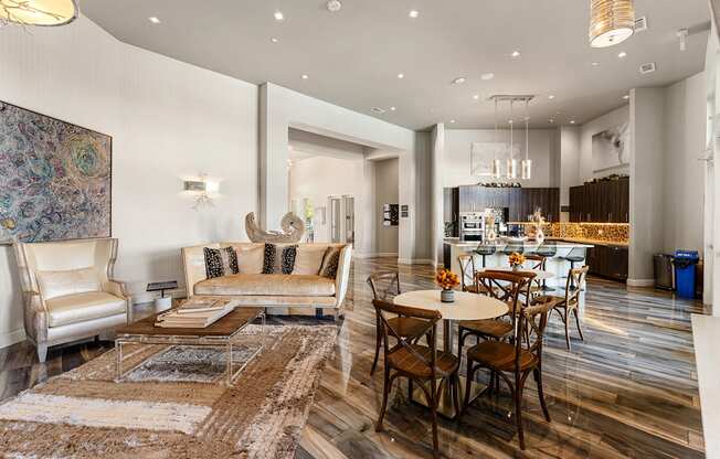 A modern living room with a large rug and a dining table set up.