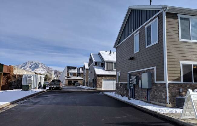 a street with houses and a mountain in the background