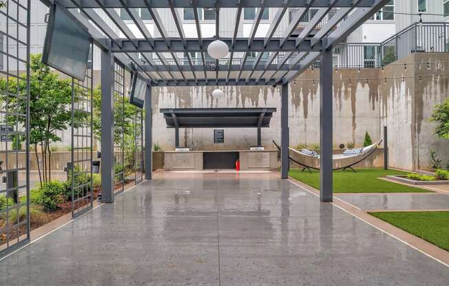 the lobby of a building with a pool and a hammock