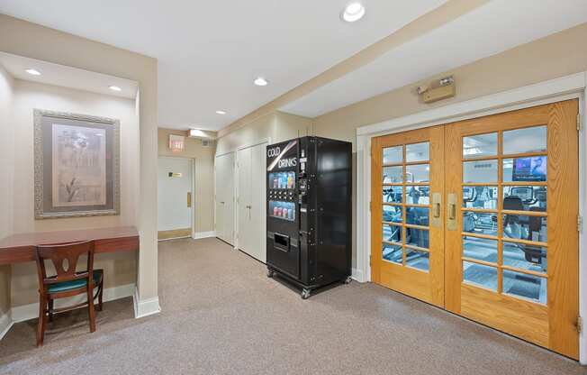 the lobby of a building with a vending machine and a table