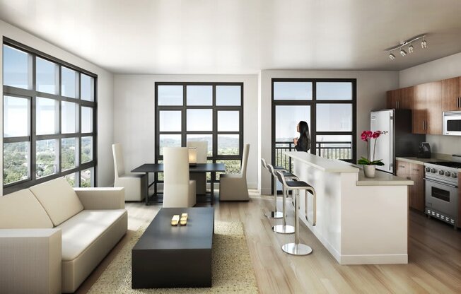 a woman standing in a living room next to a kitchen  at The Sheffield Englewood, Englewood, New Jersey