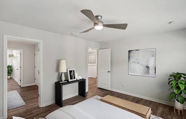 a bedroom with a large bed and a ceiling fan