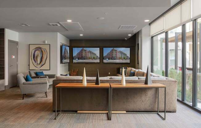 A modern office space with a large desk and a couch at Regatta Sloans Lake Apartments, Denver