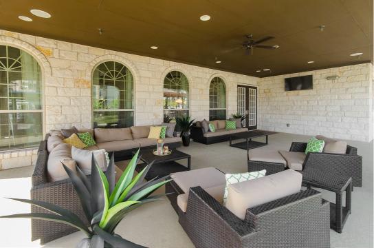 A patio with a table and chairs.