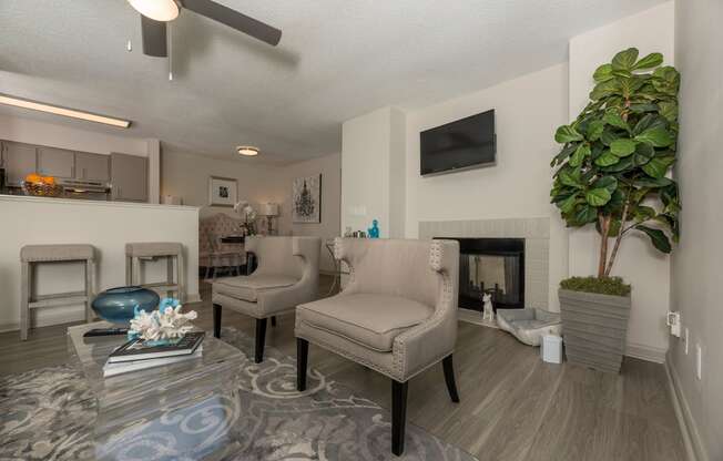 a living room with couches and chairs and a fireplace