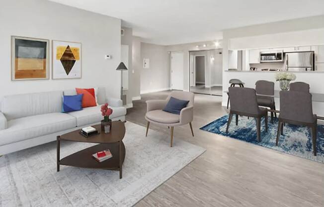 a living room and dining room area with a couch and a table