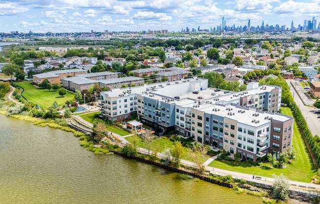 A large body of water is in the foreground of a cityscape.