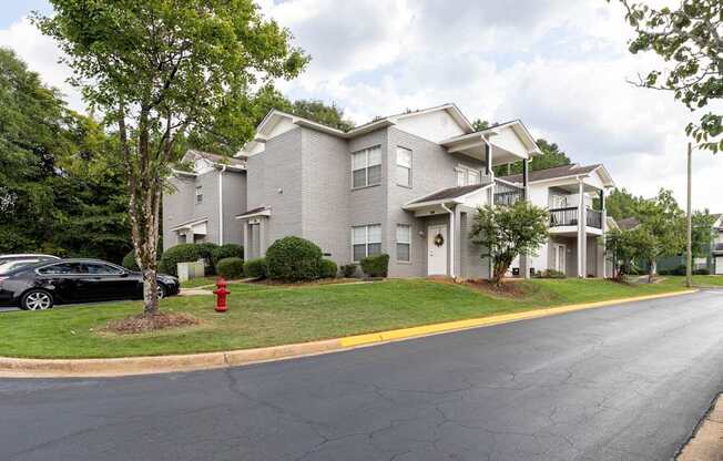 A black car is parked on the side of a street.