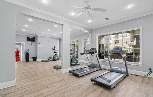 A spacious gym with treadmills and exercise equipment.
