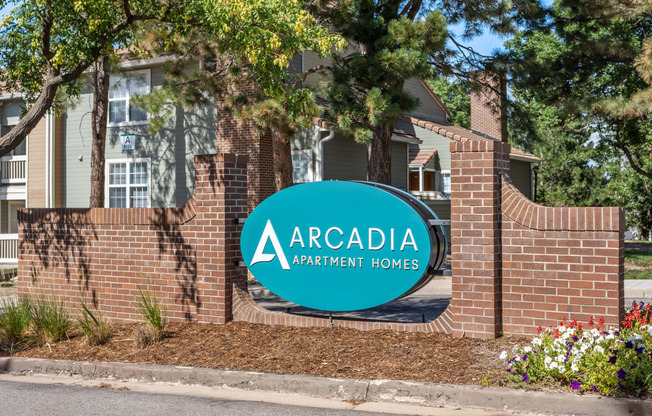 our sign in front of a brick building at Arcadia Apartments, Colorado, 80112
