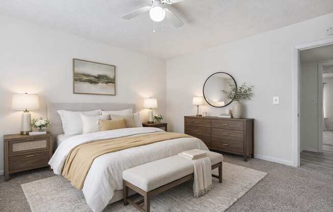 A bedroom with a bed, nightstands, and a rug.