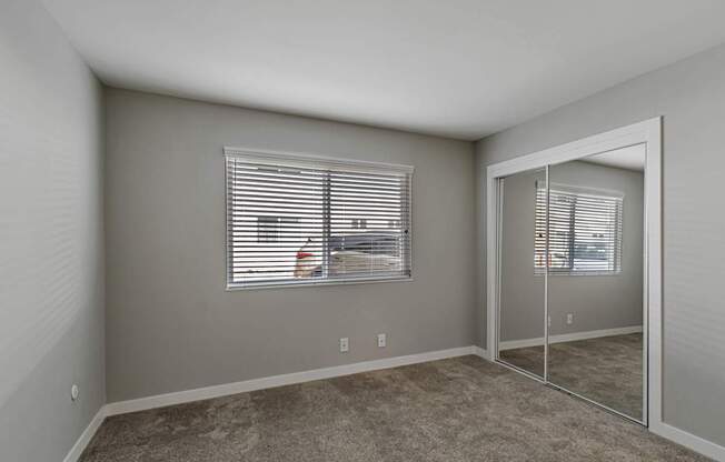 A room with a carpeted floor and a sliding glass door.