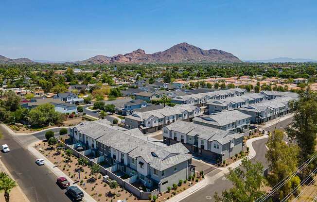 A large housing development with a mountain in the background.