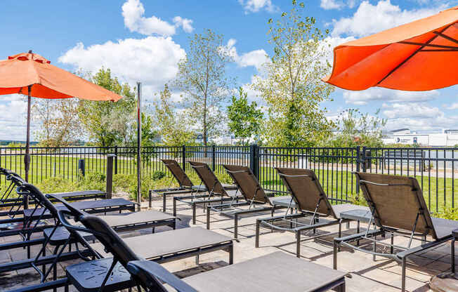 A row of chairs and tables are set up on a patio.