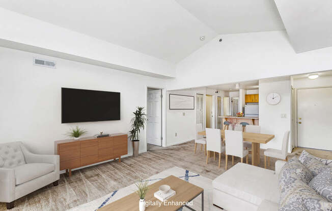 A living  and dining room with a flat screen TV mounted on the wall at Colonial Pointe at Fairview Apartments, Bellevue, Nebraska