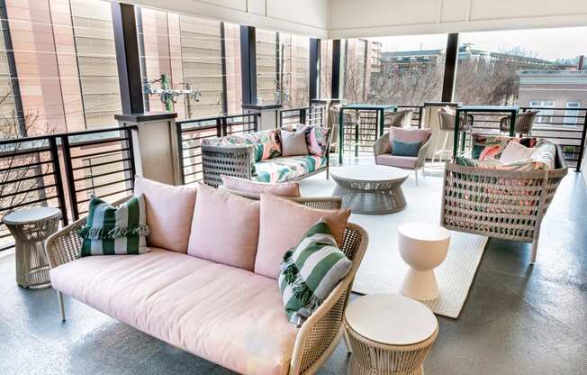 a rooftop seating area with couches and tables
