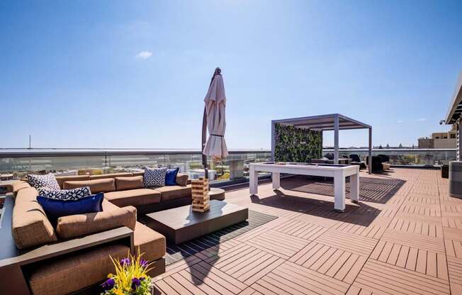 A patio with a white table and brown couches.