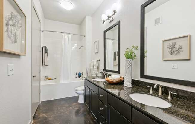 Model bathroom with two sinks and a shower at Harlow River Oaks in Houston, TX