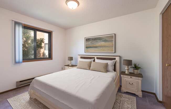 Mandan, ND Garden Grove Apartments. A bedroom with a bed and two night stands