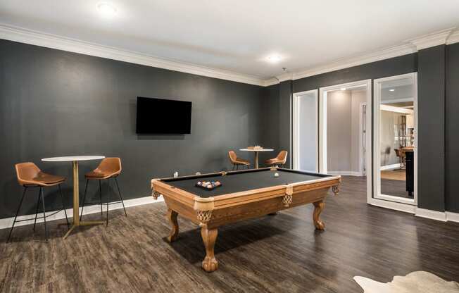 a games room with a pool table and a tv at Arlo Luxury homes Apartments, Little Rock, Arkansas