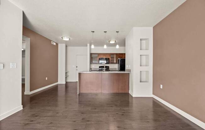 an empty living room with a kitchen in the background at Wilmington Flats Apartments, Salt Lake City, UT