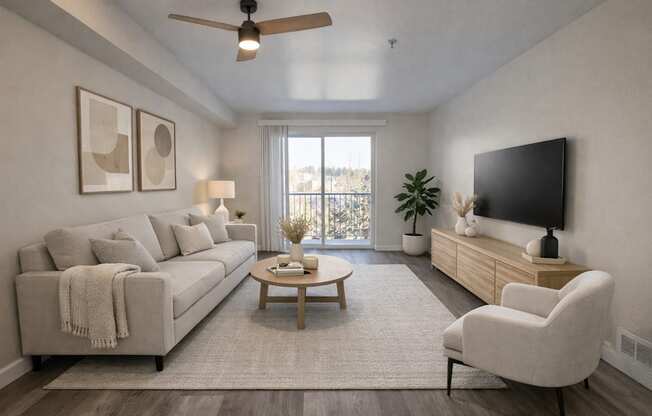 A living room with a couch, a chair, a coffee table, and a flat-screen TV.