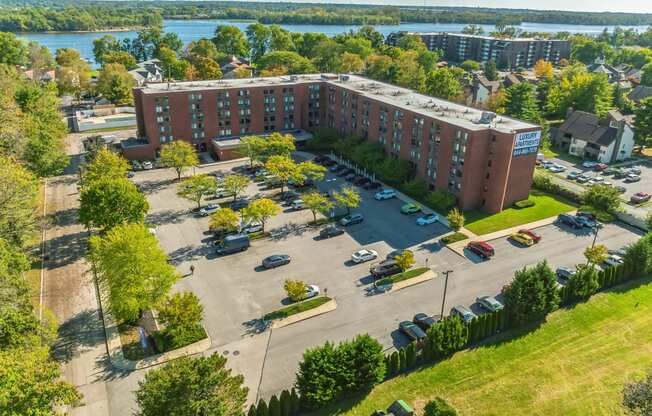 an aerial view of a parking lot in front of a building