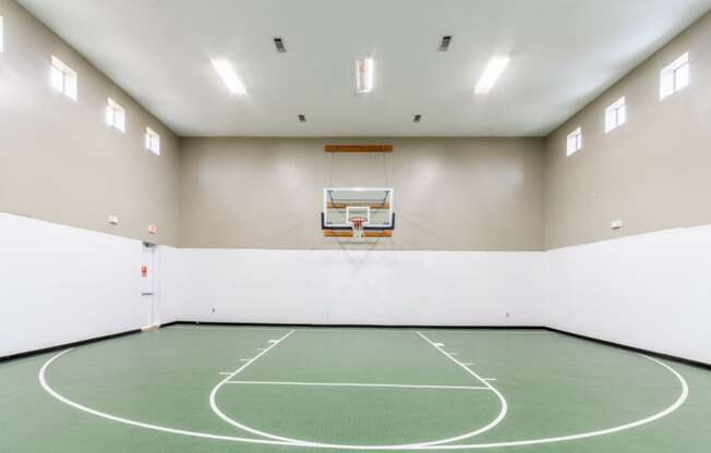 a basketball court in an empty gym
