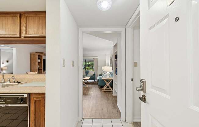 A hallway with a white door and a tiled floor at Hampton Apartments, Clearwater, Florida