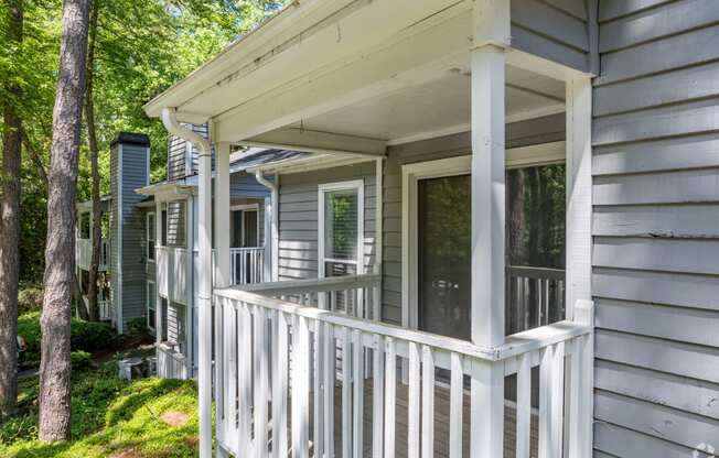 the front porch of a house with a white railing