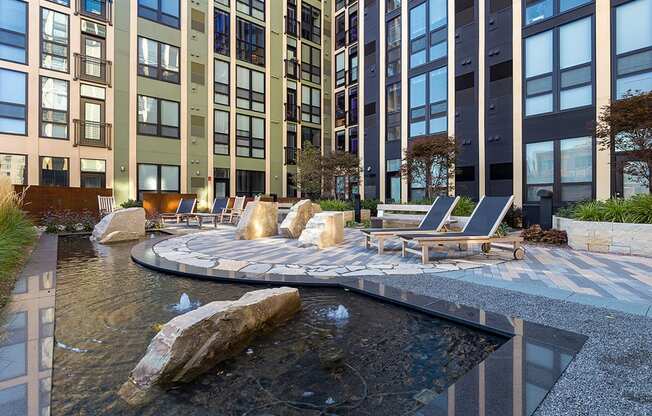 a view of a fountain in front of an apartment building at Ann Arbor City Club, Ann Arbor, MI