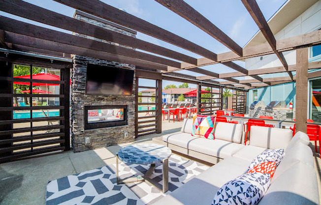 a patio with couches and a fireplace
