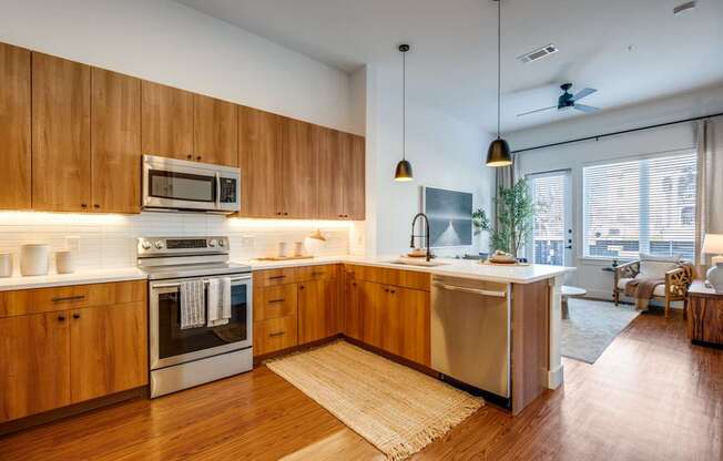 A modern kitchen with wooden cabinets and stainless steel appliances.