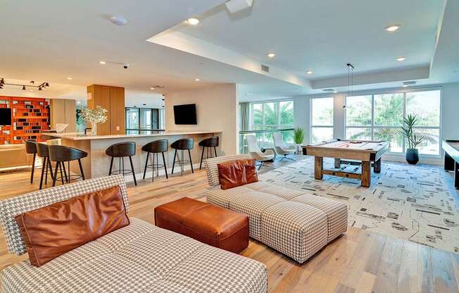 Clubhouse lounge with shuffleboard, pool table and bar area