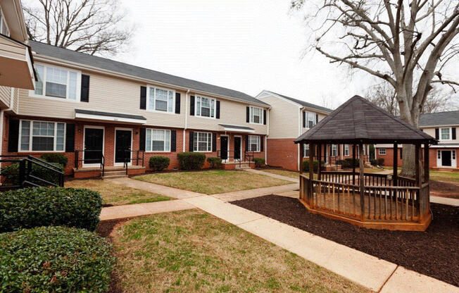 a gazebo in the front yard of an apartment complex