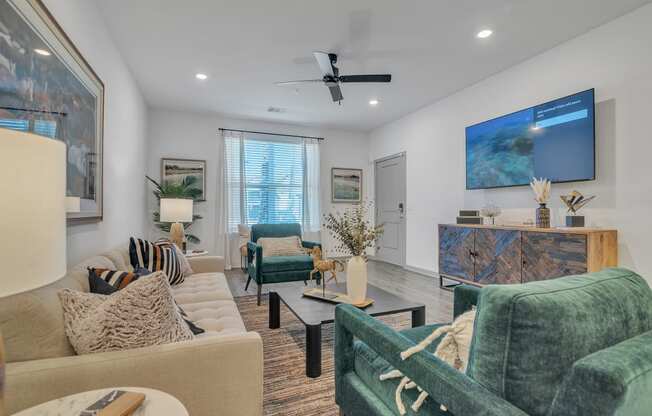 a living room with couches and chairs and a tv at Canter, Ocala, 34474