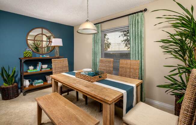 a dining room with a table and chairs and a window